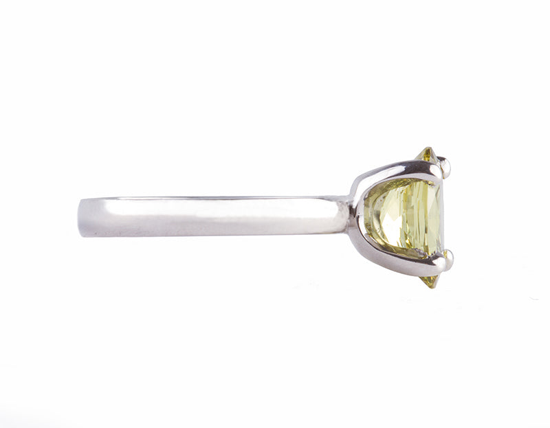 Platinum ring set with an oval chrysoberyl. The gem shows flashes of yellows, greens, browns etc. The gem is prong set and sits above the band.