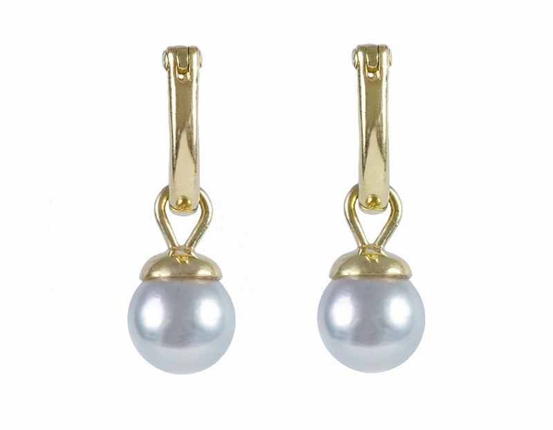 Small silver-blue pearl drops with green gold cap. Drops hang from small U shaped hoops in green gold.