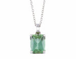 Green gem in platinum setting on platinum chain.