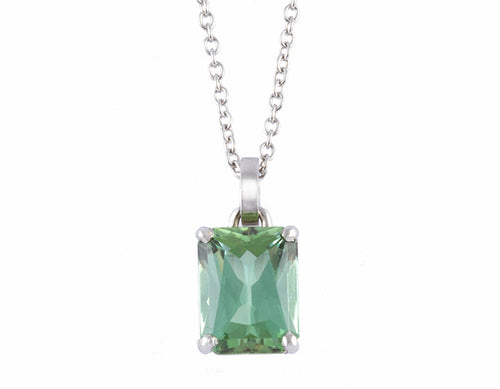 Green gem in platinum setting on platinum chain.