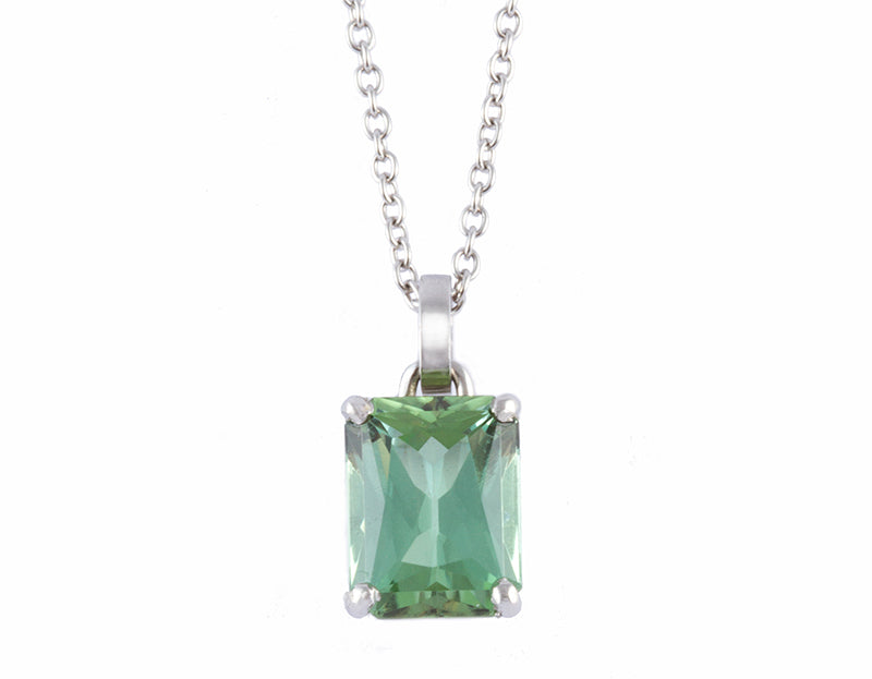 Green gem in platinum setting on platinum chain.