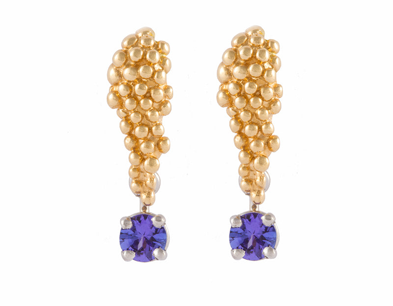 Pair of yellow gold studs in the shape of a bunch of grapes carved in detail in relief. Hanging from the bottom are a pair of purple blue round tanzanites.