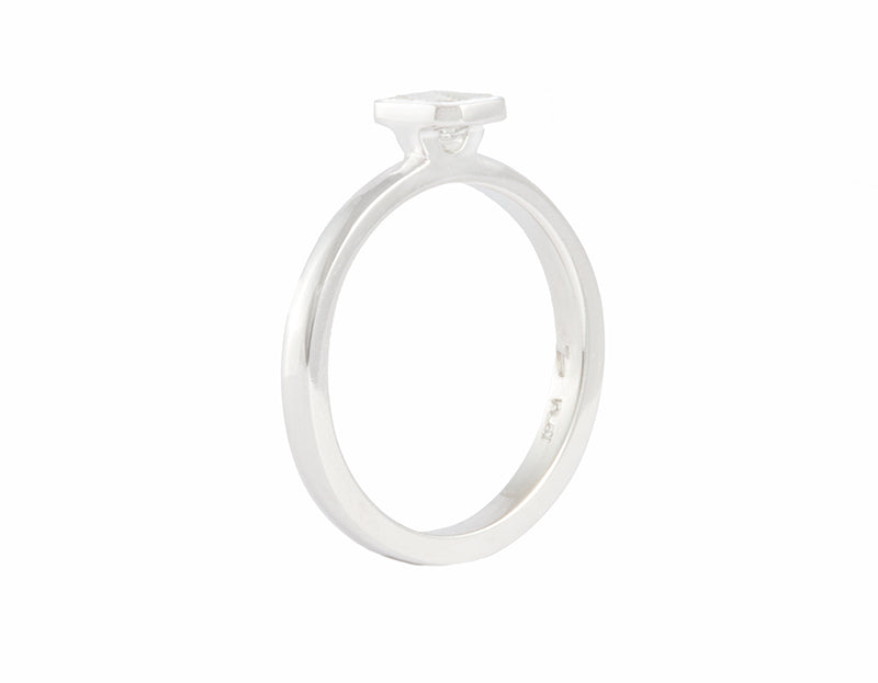Thin platinum ring set with an octagon cut diamond. Gem is frame or bezel set and sits above the band.