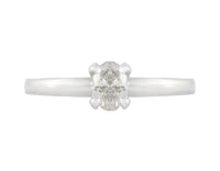 Thin platinum ring set with oval diamond.  Diamond is pong set, runs parallel to the finger and sits above the band.