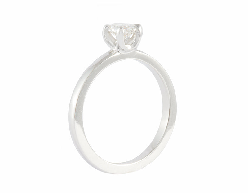 Thin platinum ring set with oval diamond.  Diamond is pong set, runs parallel to the finger and sits above the band.