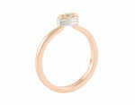 Thin rose gold ring set with a round diamond. Diamond setting is encircled by platinum wire, looks like it is lashed in.