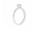 Thin platinum ring set with round pink spinel.  the gem is set in a frame and sits above the band.