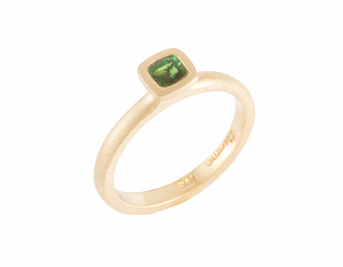 Thin yellow gold ring set with rich medium green tsavorite garnet.  The garnet is square, set in a frame, and sits above the band.