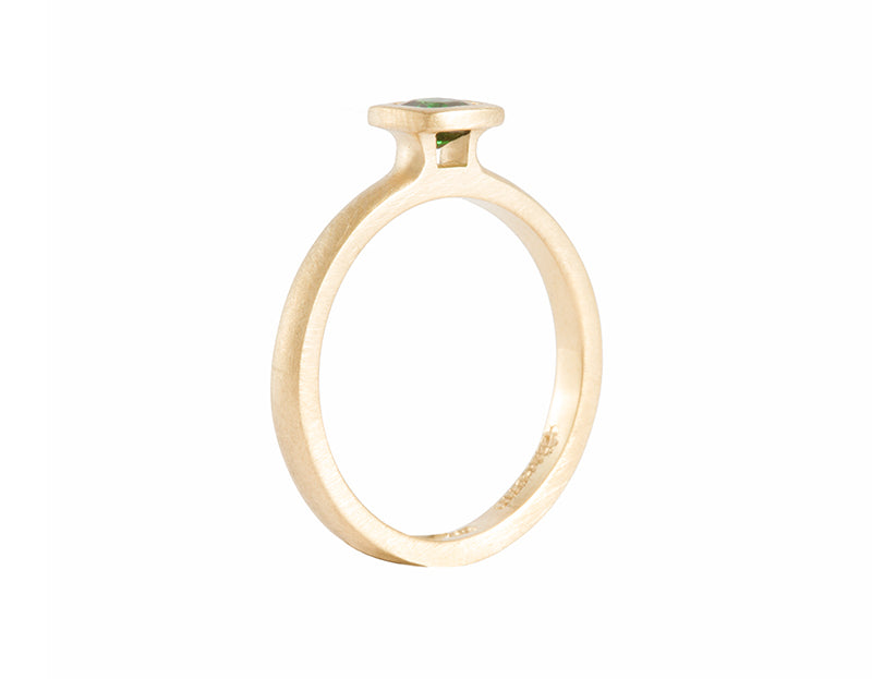 Thin yellow gold ring set with rich medium green tsavorite garnet.  The garnet is square, set in a frame, and sits above the band.