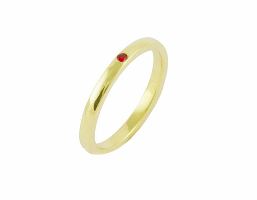 Thin green gold band set with one bright red round ruby. The gems are set into the band.