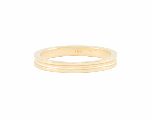 Thin 18 karat yellow gold band with a trench running all around the band.  Recessed are in trench is matte finish, rest of band high polished.