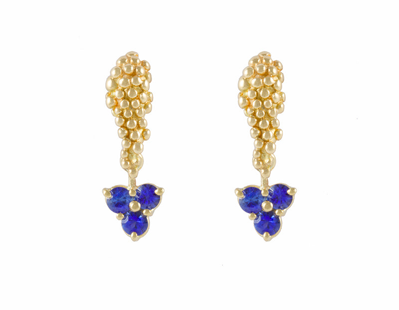 Trio of blue sapphire drops hung on yellow gold Grapes studs.