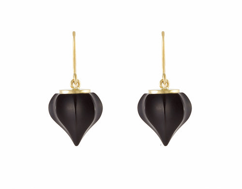 Earrings. Carved black gems coming to a point with yellow gold cap and wires.