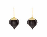 Earrings. Carved black gems coming to a point with yellow gold cap and wires.