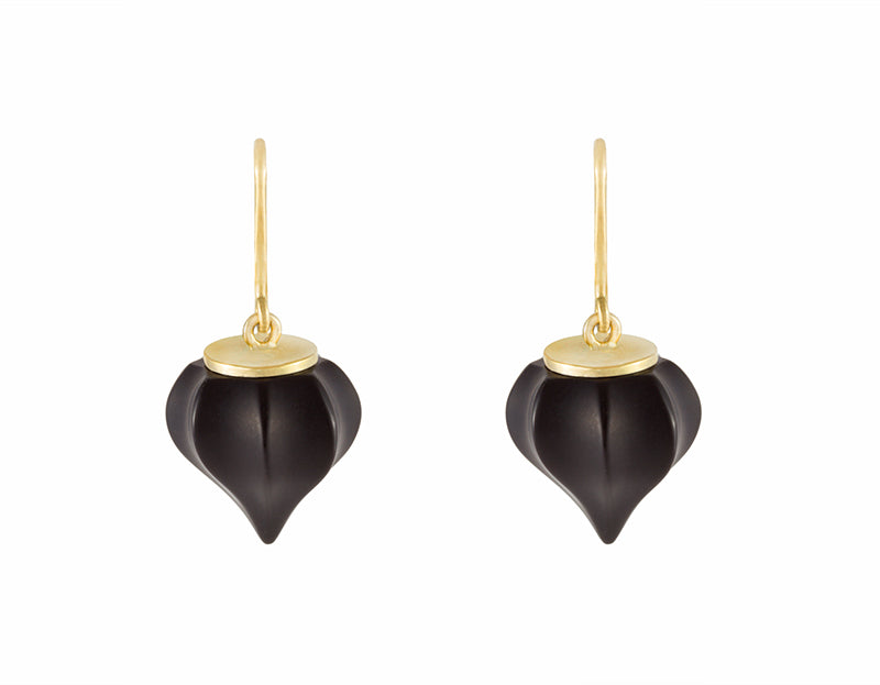 Earrings. Carved black gems coming to a point with yellow gold cap and wires.
