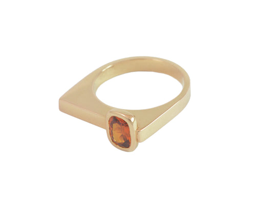 Small rectangle orange gem off-set in rose gold ring.