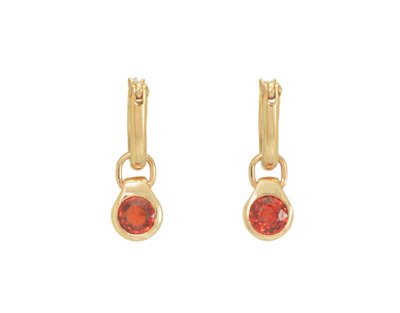 Round drops with bright orange gems in rose gold frame. Drops hang on small U shaped hoops in solid rose gold.