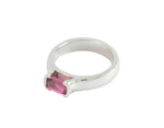 Platinum ring with oval deep pink sapphire bezel set at two ends.