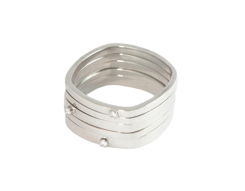Stack of five thin rings 18k white gold, square, three have micro diamonds.