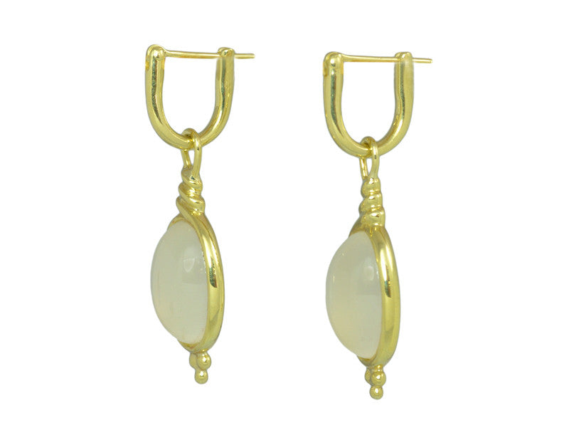 Oval drops with white moonstone cabochon gem in green gold frame. Drops hang on small U shaped hoops in solid green gold.