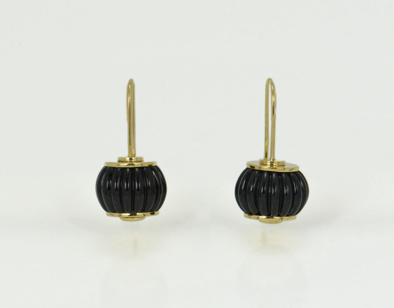 White gold earrings with clear white gems carved like a barrel.