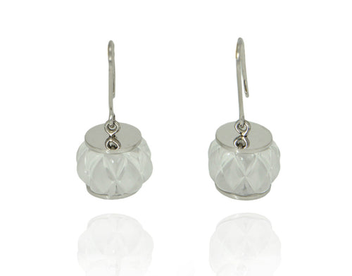 White gold earrings with clear white gems carved like a barrel.