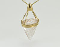 Very large pear shaped gem clear white with golden threads, intricate gold cap and chain.