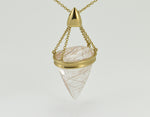 Very large pear shaped gem clear white with golden threads, intricate gold cap and chain.