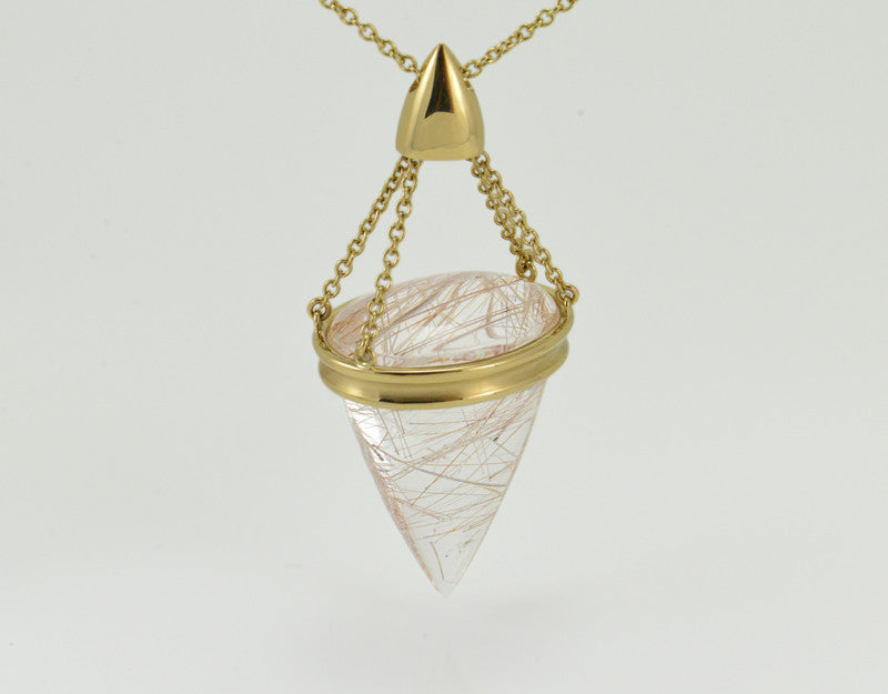 Very large pear shaped gem clear white with golden threads, intricate gold cap and chain.