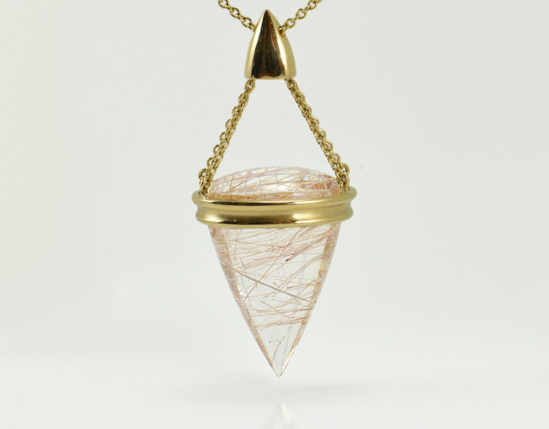 Very large pear shaped gem clear white with golden threads, intricate gold cap and chain.