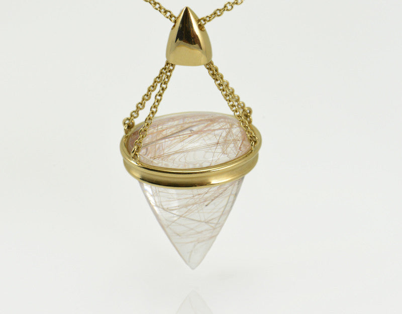 Very large pear shaped gem clear white with golden threads, intricate gold cap and chain.