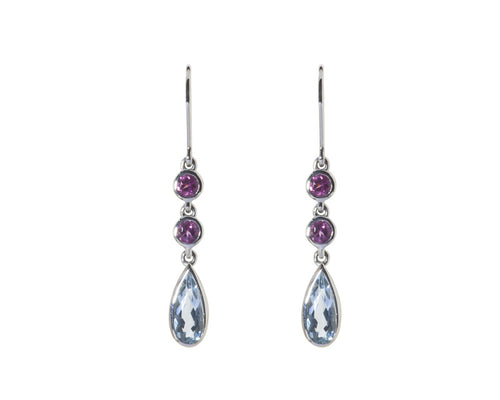 Earrings with pear shaped light blue aquamarine and round pink gems in white gold.