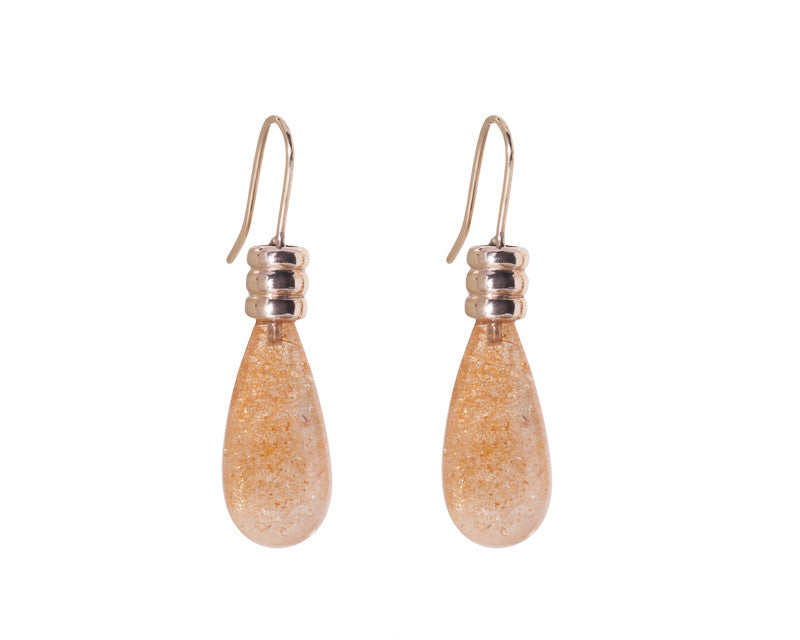 Long pear shaped sparky orange gems in rose gold cap and shepherd's hooks.