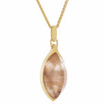 Long clear gem pointed at both ends with golden threads in the gem set in yellow gold pendant.