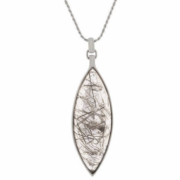 Very long clear gem pointed at two ends illed with black crystal threads in white gold.