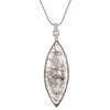 Very long clear gem pointed at two ends illed with black crystal threads in white gold.