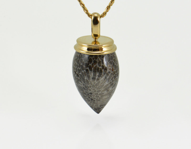 Very long pear shaped gem mottled grey and black with yellow gold cap and chain.