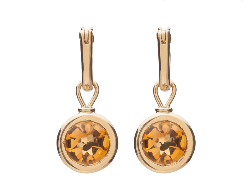Round drops with bright orange gems in rose gold frame. Drops hang on small U shaped hoops in solid rose gold.