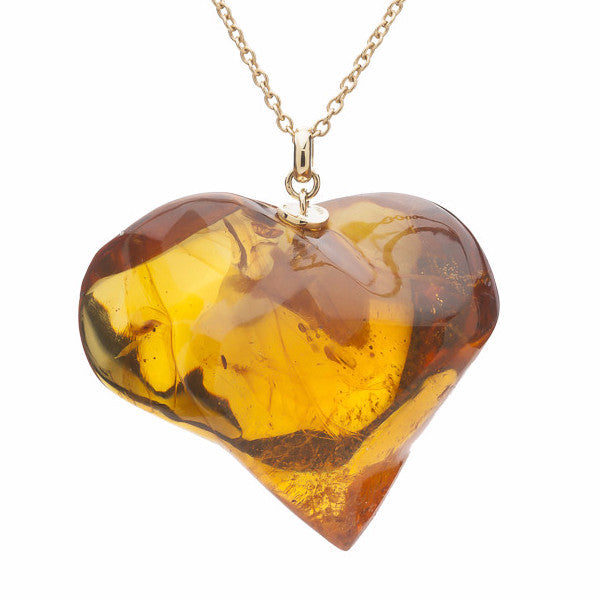 Very large asymmetric heart in golden amber with yellow gold cap and chain..