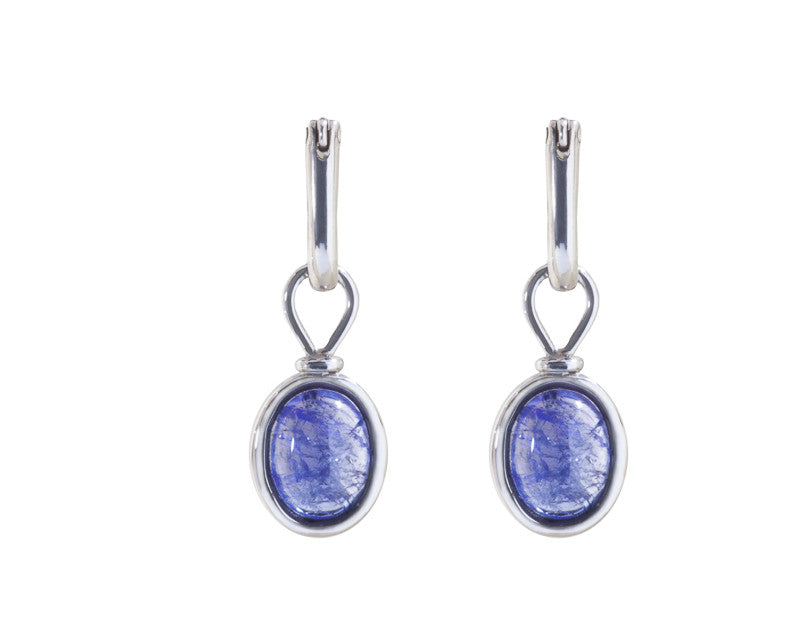 Oval drops with light purple-blue cabochon gem in white gold frame. Drops hang on small U shaped hoops in solid white gold.