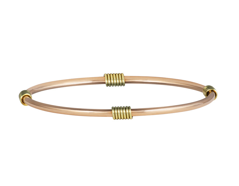 Solid rose gold bangle, round wire, lashed with green gold wire.