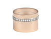 Very wide rose gold band with a long row of diamonds close to one edge of the band.