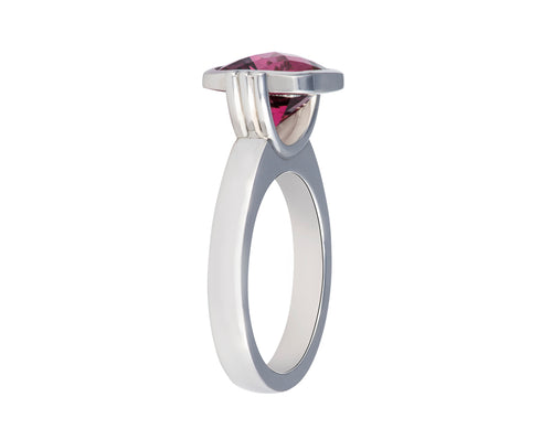 Platinum ring with cushion shaped deep pink gem with checkerboard pattern.