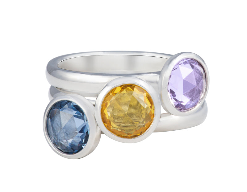 Trio of platinum rings that stack together set with rose cut pink, yellow, blue sapphires.