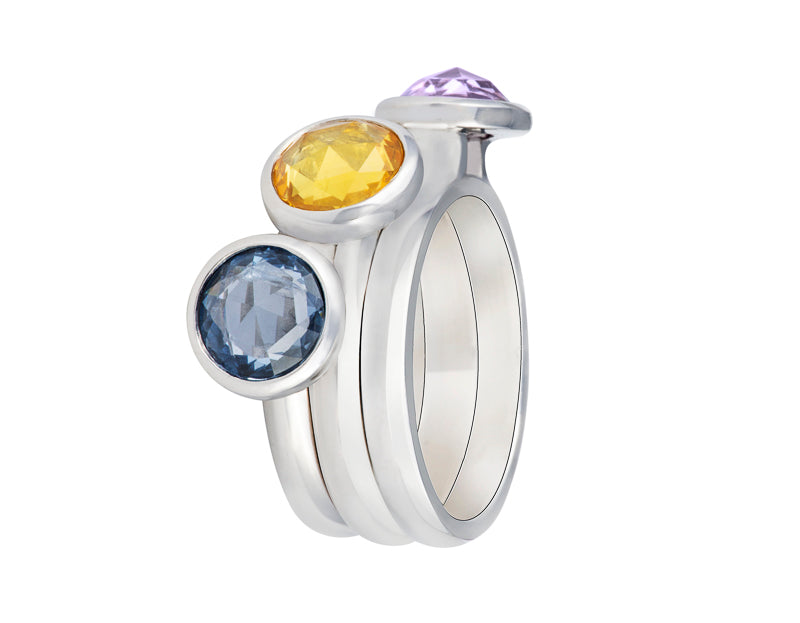 Trio of platinum rings that stack together set with rose cut pink, yellow, blue sapphires.