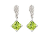 Pair of platinum studs in the shape of a bunch of grapes carved in detail in relief. Hanging from the bottom are bright green square peridot.