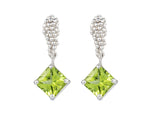 Pair of platinum studs in the shape of a bunch of grapes carved in detail in relief. Hanging from the bottom are bright green square peridot.