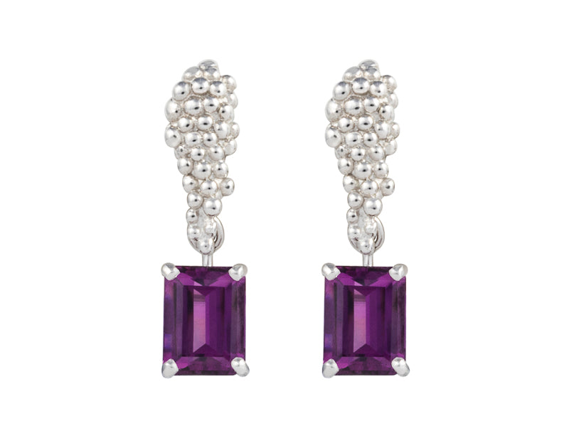 Pair of platinum studs in the shape of a bunch of grapes carved in detail in relief. Hanging from the bottom are a pair of rich purple rectangular rhodolite garnets.