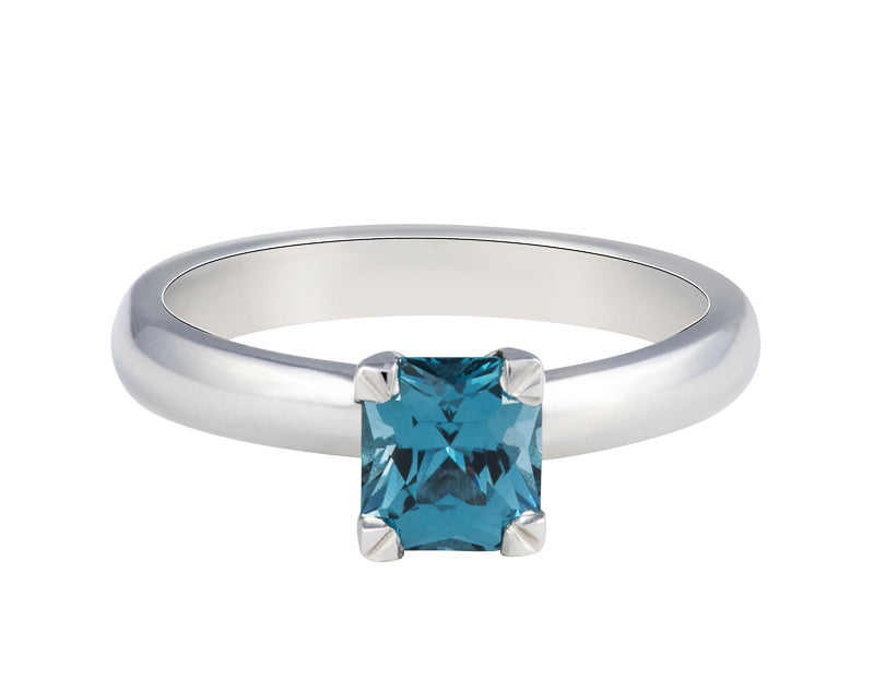 Platinum ring set with medium blue spinel.  The spinel is rectangular and prong set and sits above the band.