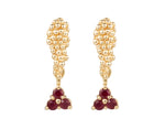 Pair of yellow gold studs in the shape of a bunch of grapes carved in detail in relief. Hanging from the bottom are trios of round red rubies forming a triangle.